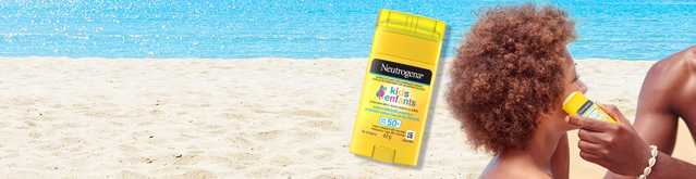 Banner including a father using Neutrogena® Kids Sunscreen Stick SPF 50+ on his kid’s face on the beach.